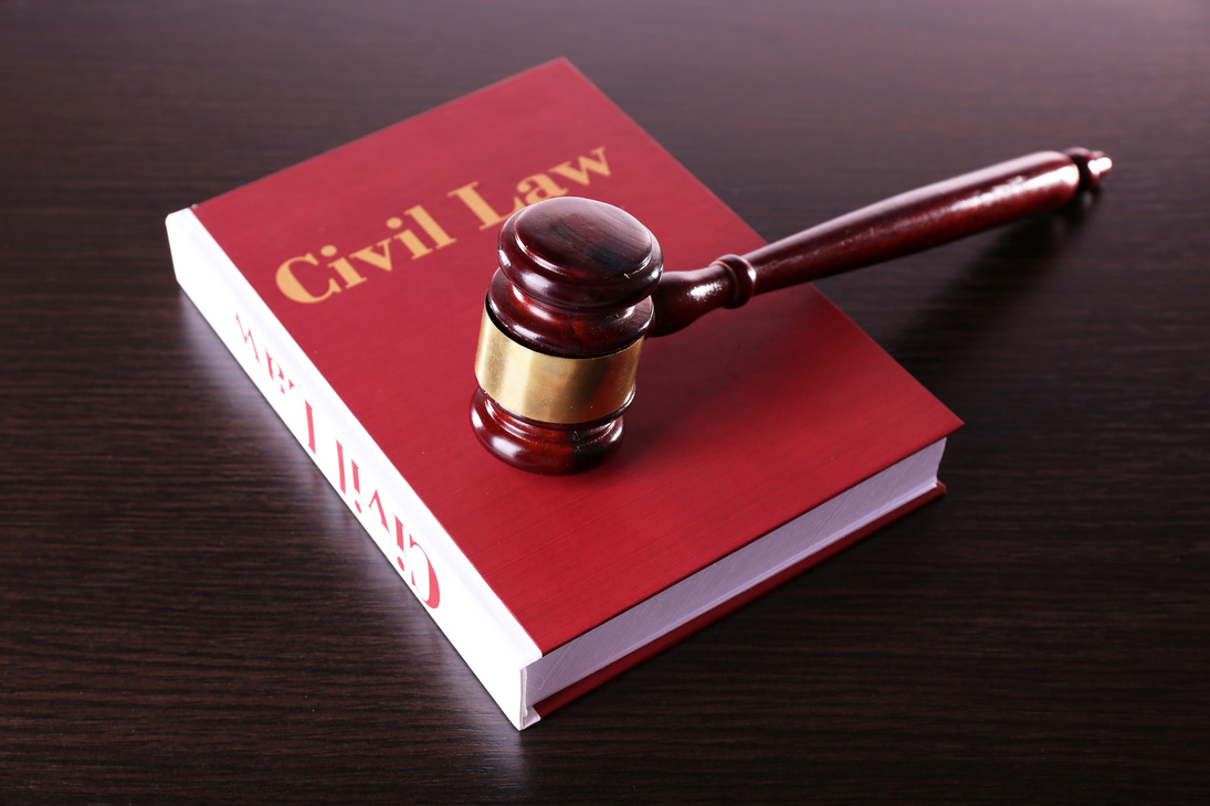 Civil Law Book with Hammer on Wooden Table